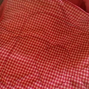 Red and white reversible twin comforter.  And pillow sham